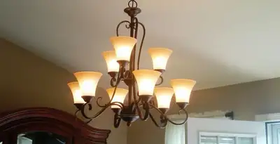 Classic ceiling chandelier installation with warm lighting in Detroit, MI