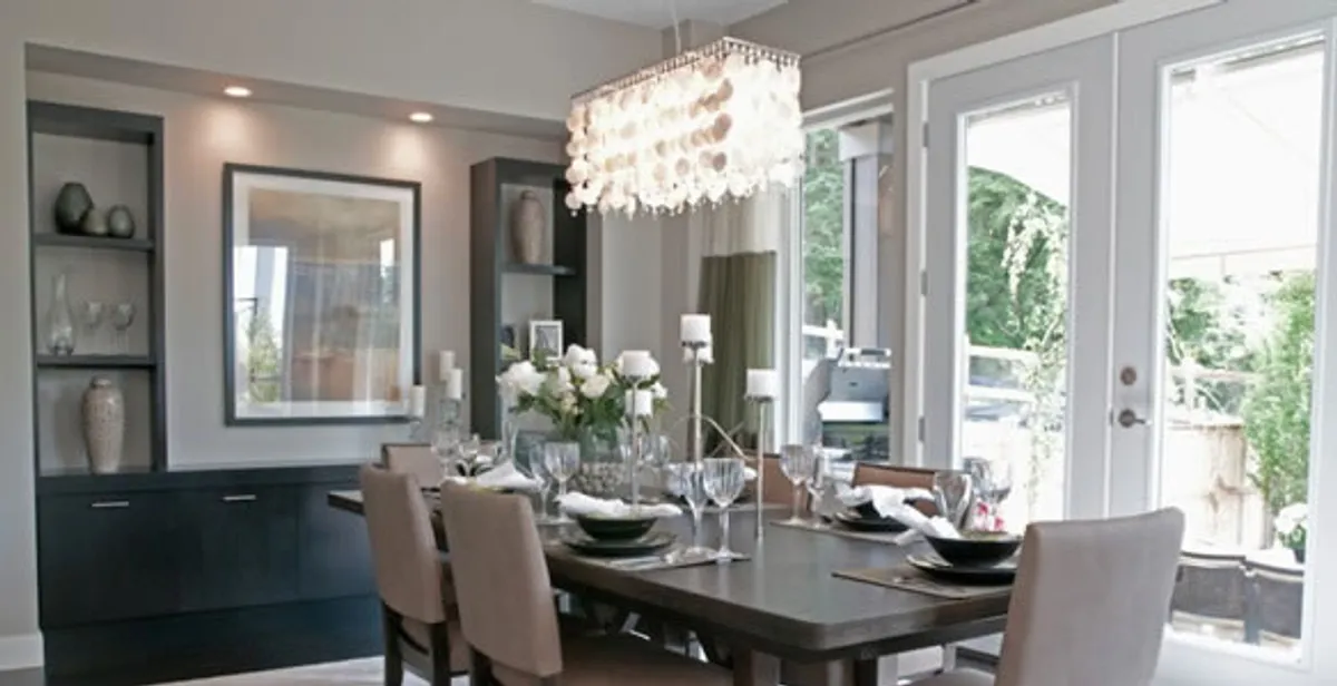 Elegant dining room chandelier installation above table in Detroit, MI