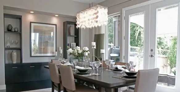 Elegant dining room chandelier installation above table in Detroit, MI