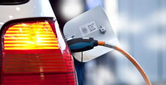 Electric car plugged into EV charger after professional installation in Detroit, MI