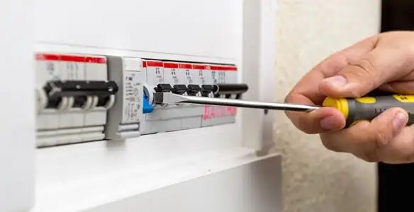 electrical panel upgrade service showing technician adjusting circuit breakers during system upgrade in Detroit, MI