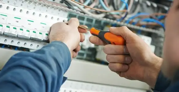 electrical service showing licensed electrician performing electrical panel maintenance and adjustments in Detroit, MI