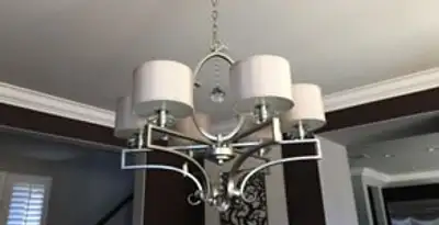 Modern chandelier installation with multiple light fixtures in Detroit, MI