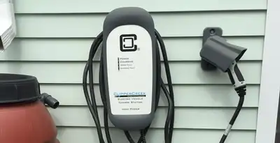 Outdoor electric vehicle charger installation on residential wall in Detroit, MI