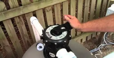 pool pumps service showing professional adjustment of pool pump control system in Detroit, MI